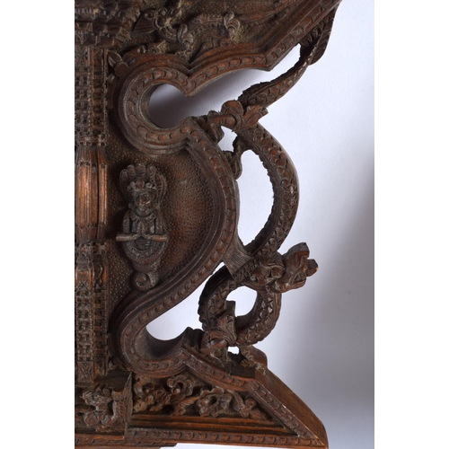 543 - A 19TH CENTURY BURMESE JAVANESE CARVED WOOD TEMPLE PANEL together with a similar Nepalese carved woo... 