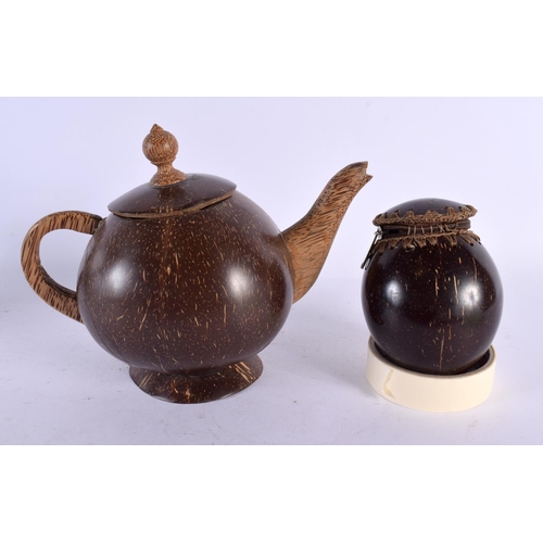 550 - AN UNUSUAL TRIBAL CARVED COCONUT TEAPOT AND COVER together with a similar coconut purse. Largest 21 ... 