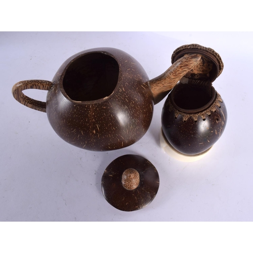 550 - AN UNUSUAL TRIBAL CARVED COCONUT TEAPOT AND COVER together with a similar coconut purse. Largest 21 ... 