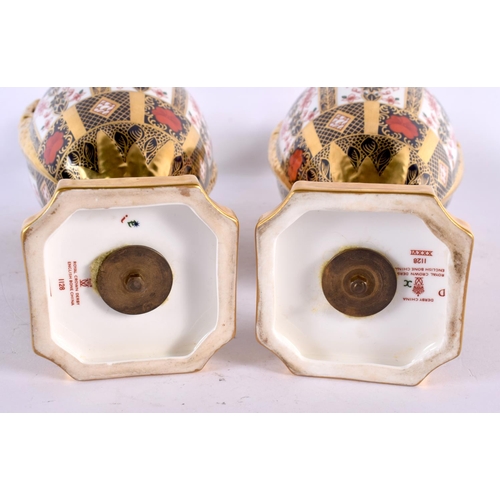 559 - A GOOD PAIR OF ROYAL CROWN DERBY TWIN HANDLED IMARI VASES AND COVERS painted with flowers. 30 cm hig... 