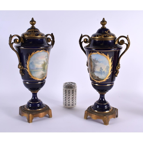 56 - A LARGE PAIR OF 19TH CENTURY FRENCH SEVRES PORCELAIN VASES AND COVERS painted with lovers in landsca... 