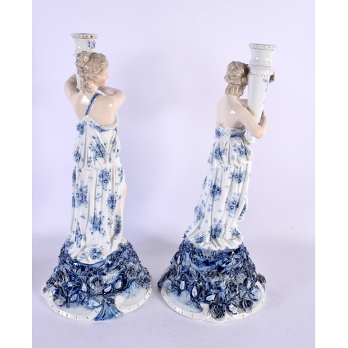 567 - A LARGE PAIR OF LATE 19TH CENTURY GERMAN PORCELAIN CANDLESTICKS formed as figures holding aloft scon... 