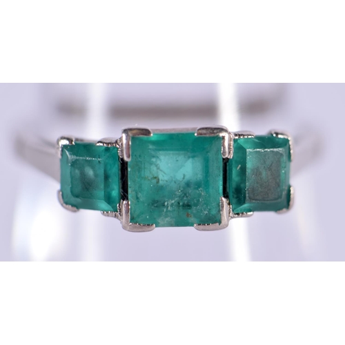 575 - AN 18CT WHITE GOLD RING SET WITH 3 EMERALDS.  Size N, weight 3.5g