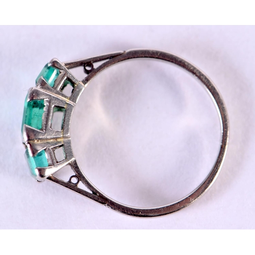 575 - AN 18CT WHITE GOLD RING SET WITH 3 EMERALDS.  Size N, weight 3.5g