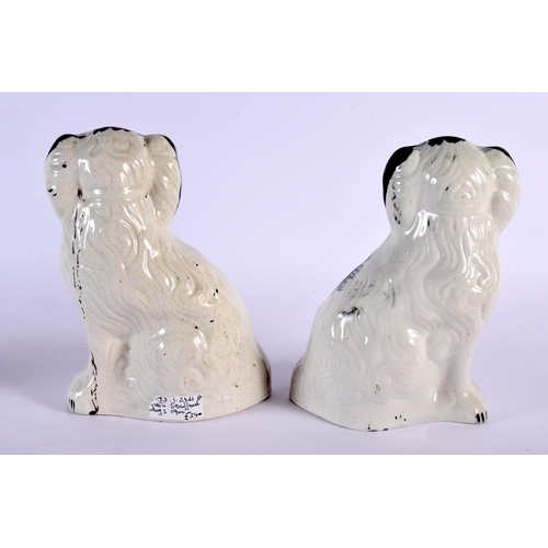 59 - A PAIR OF 19TH CENTURY STAFFORDSHIRE FIGURES OF SPANIELS. 21 cm x 12 cm.