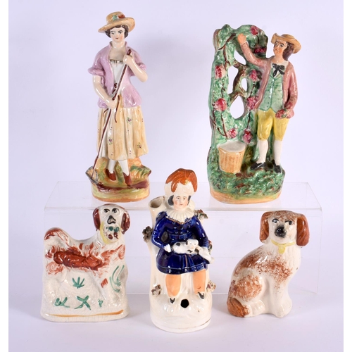 61 - THREE 19TH CENTURY STAFFORDSHIRE POTTERY FIGURES together with a pair of similar spaniels. Largest 2... 