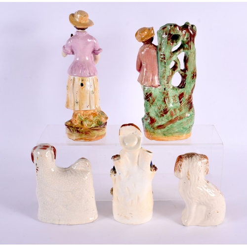 61 - THREE 19TH CENTURY STAFFORDSHIRE POTTERY FIGURES together with a pair of similar spaniels. Largest 2... 