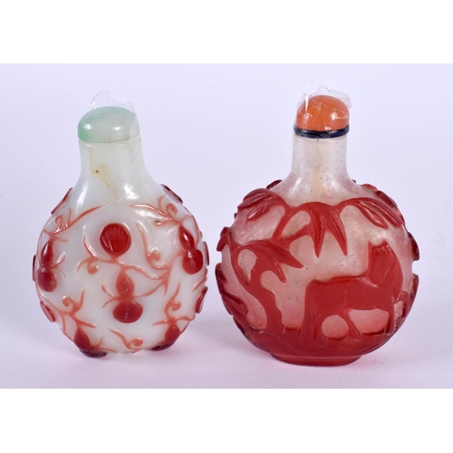 618 - TWO 19TH CENTURY CHINESE PEKING GLASS SNUFF BOTTLES AND STOPPERS decorated with foliage and animals.... 