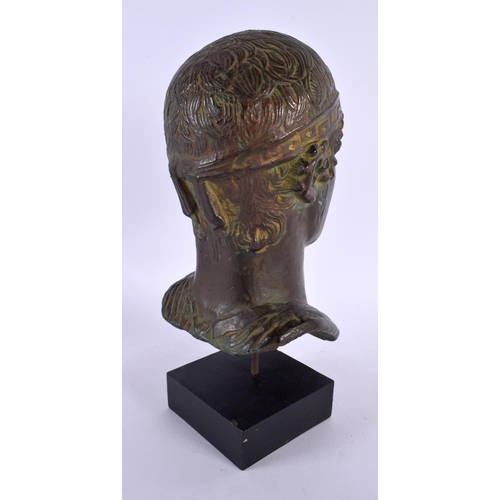 645 - A GRAND TOUR TYPE BRONZED BUST OF THE CHARIOTEER OF DELHI After the Antiquity. 23 cm high.