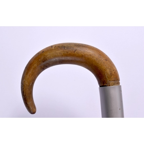 687 - AN ANTIQUE MIDDLE EASTERN CARVED RHINOCEROS HORN WALKING CANE together with a puppet. Largest 90 cm ... 