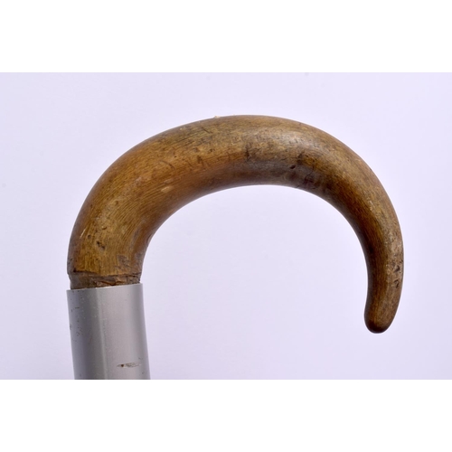 687 - AN ANTIQUE MIDDLE EASTERN CARVED RHINOCEROS HORN WALKING CANE together with a puppet. Largest 90 cm ... 