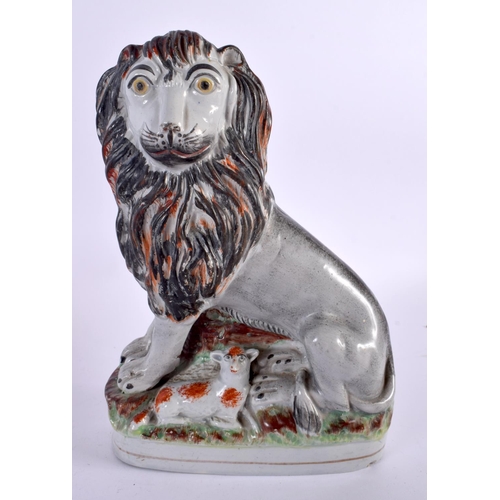 694 - A LARGE EARLY 19TH CENTURY STAFFORDSHIRE FIGURE OF A LION together with an English cup and saucer. L... 