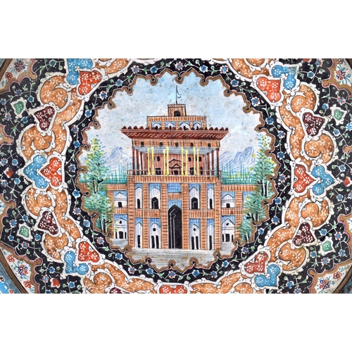 700 - A LARGE 19TH CENTURY MIDDLE EASTERN PERSIAN ENAMELLED COPPER DISH painted with buildings and birds. ... 