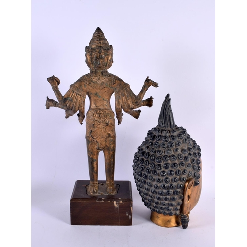 710 - A LARGE 19T CENTURY SOUTH EAST ASIAN BRONZE FIGURE OF A DEITY together with a gilded head of a buddh... 