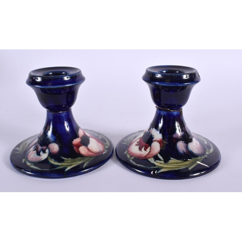 72 - A SMALL PAIR OF MOORCROFT CANDLESTICKS. 9 cm x 9 cm.