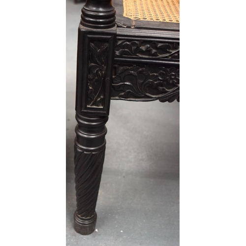 752 - A FINE EARLY 19TH CENTURY ANGLO INDIAN CARVED HARDWOOD SETTEE decorated with foliage and extensive v... 