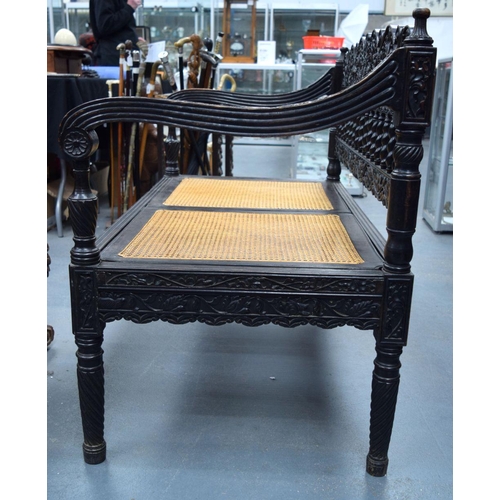 752 - A FINE EARLY 19TH CENTURY ANGLO INDIAN CARVED HARDWOOD SETTEE decorated with foliage and extensive v... 