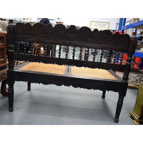 752 - A FINE EARLY 19TH CENTURY ANGLO INDIAN CARVED HARDWOOD SETTEE decorated with foliage and extensive v... 