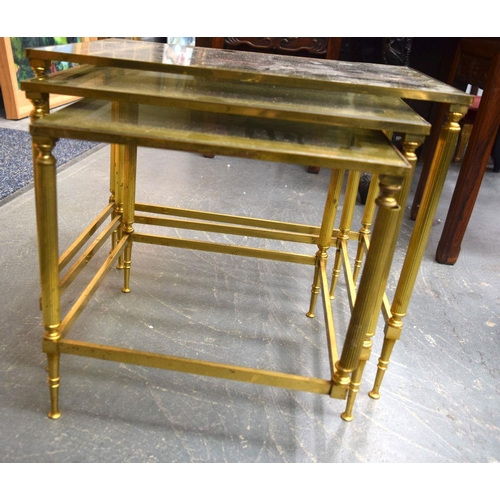 753 - A NEST OF THREE MID CENTURY BRASS GLASS TOPPED TABLES. Largest 52 cm x 36 cm. (3)