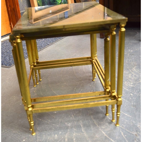 753 - A NEST OF THREE MID CENTURY BRASS GLASS TOPPED TABLES. Largest 52 cm x 36 cm. (3)