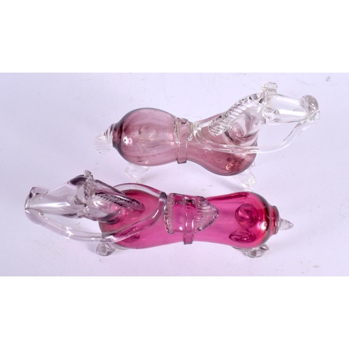 770 - A PAIR OF CRANBERRY AND CLEAR GLASS HORSE DECANTERS. 22 cm x 15 cm.