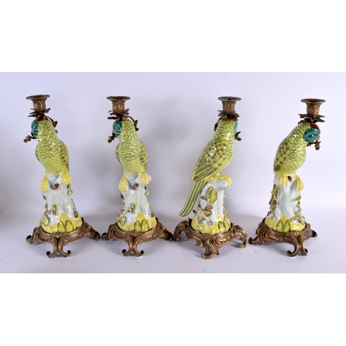 779 - A SET OF FOUR CONTINENTAL BRONZE POTTERY BIRD CANDLESTICKS. 36 cm high.