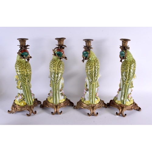 779 - A SET OF FOUR CONTINENTAL BRONZE POTTERY BIRD CANDLESTICKS. 36 cm high.