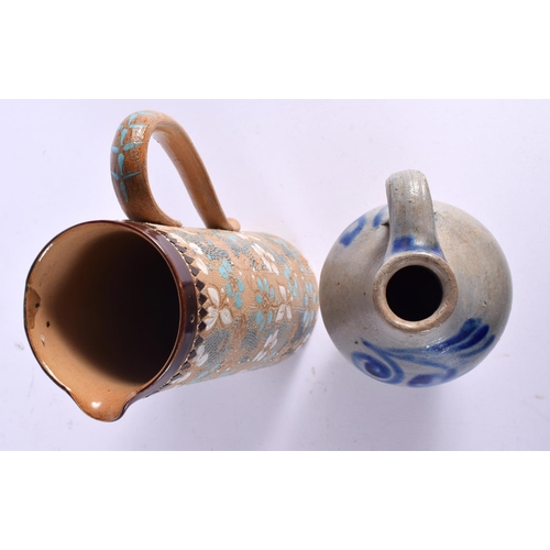 781 - AN ANTIQUE DOULTON LAMBETH JUG together with a stoneware jug. Largest 21 cm high. (2)