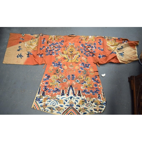 783 - A LARGE 19TH CENTURY CHINESE ORANGE SILK WORK EMBROIDERED DRAGON ROBE together with a rank badge and... 