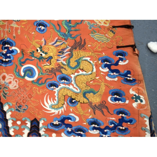 783 - A LARGE 19TH CENTURY CHINESE ORANGE SILK WORK EMBROIDERED DRAGON ROBE together with a rank badge and... 