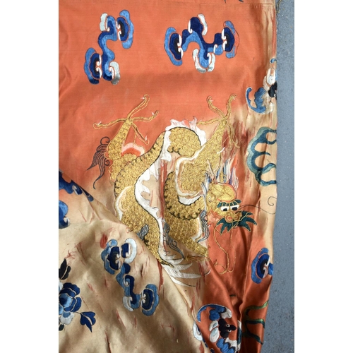 783 - A LARGE 19TH CENTURY CHINESE ORANGE SILK WORK EMBROIDERED DRAGON ROBE together with a rank badge and... 