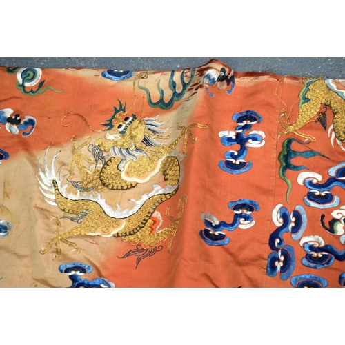 783 - A LARGE 19TH CENTURY CHINESE ORANGE SILK WORK EMBROIDERED DRAGON ROBE together with a rank badge and... 