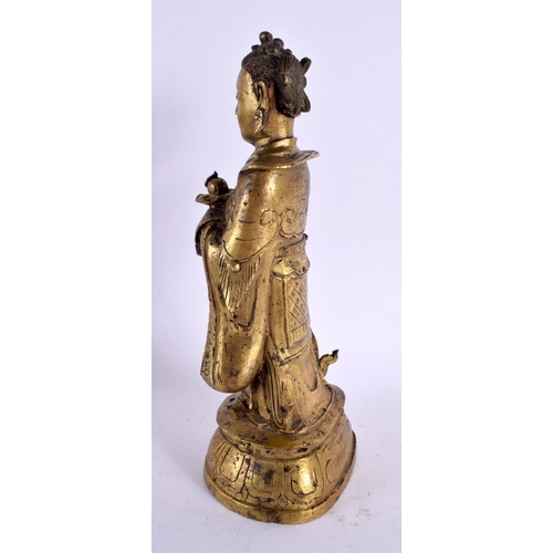 784 - A 17TH CENTURY CHINESE GILT BRONZE FIGURE OF AN IMMORTAL Ming/Qing. 24 cm high.