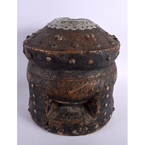 798 - A LARGE ANTIQUE NORTH AFRICAN BEDOUIN CARVED WOOD PESTLE AND MORTAR overlaid with stud work. 68 cm h... 