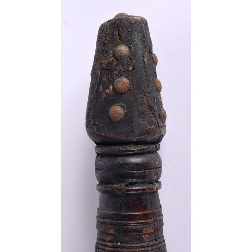 798 - A LARGE ANTIQUE NORTH AFRICAN BEDOUIN CARVED WOOD PESTLE AND MORTAR overlaid with stud work. 68 cm h... 