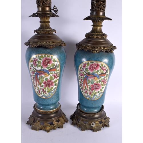 799 - A LARGE PAIR OF 19TH CENTURY FRENCH PORCELAIN COUNTRY HOUSE LAMPS painted with birds. 58 cm high.