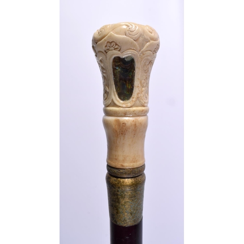 804 - A CARVED BONE AND MOTHER OF PEARL WALKING CANE. 90 cm long.