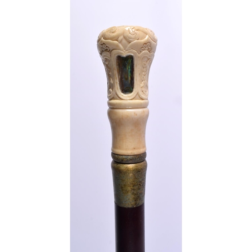 804 - A CARVED BONE AND MOTHER OF PEARL WALKING CANE. 90 cm long.