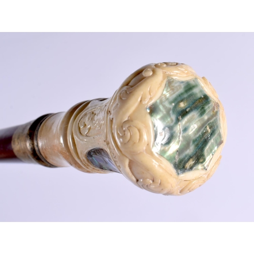 804 - A CARVED BONE AND MOTHER OF PEARL WALKING CANE. 90 cm long.