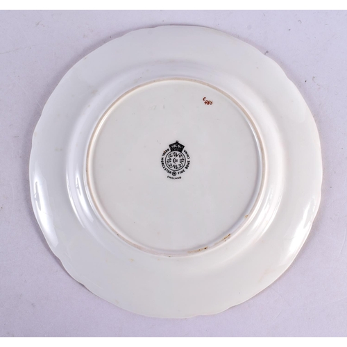 95 - A ROYAL WORCESTER CLARET GROUND CABINET PLATE by Higgins. 20 cm diameter.