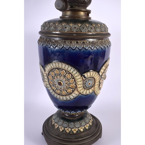 13 - A LARGE ANTIQUE DOULTON STONEWARE OIL LAMP decorated with flowers and motifs. 54 cm x 12 cm.