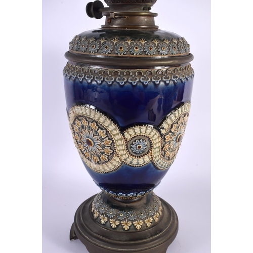 13 - A LARGE ANTIQUE DOULTON STONEWARE OIL LAMP decorated with flowers and motifs. 54 cm x 12 cm.