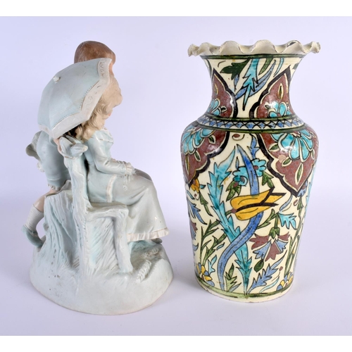 14 - AN ANTIQUE BISQUE PORCELAIN FIGURE together with a Middle Eastern vase. Largest 27 cm x 15 cm. (2)