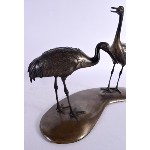 142 - A LARGE 19TH CENTURY JAPANESE MEIJI PERIOD BRONZE OKIMONO modelled as two standing birds upon a shap... 