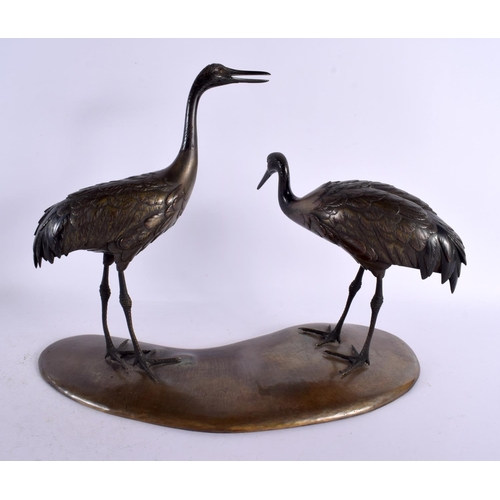 142 - A LARGE 19TH CENTURY JAPANESE MEIJI PERIOD BRONZE OKIMONO modelled as two standing birds upon a shap... 