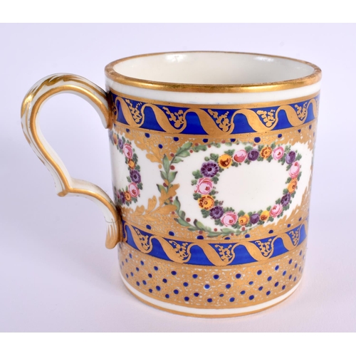 149 - Sevres large coffee can painted with wreaths of flowers and ornately gilded on a cobalt blue ground ... 