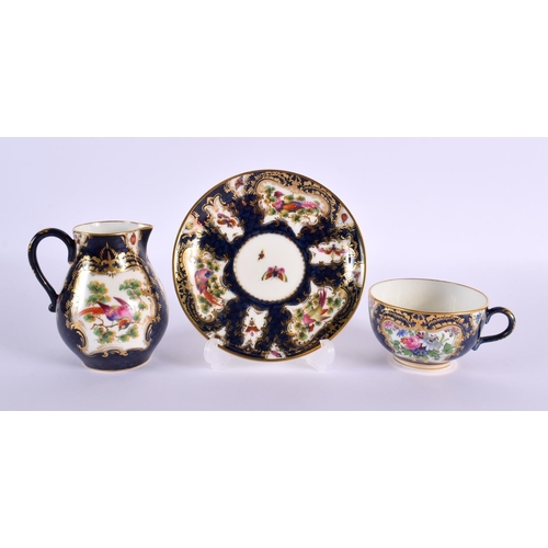 208 - Royal Worcester teacup and saucer and matching cream jug painted with exotic birds in gilt panel on ... 