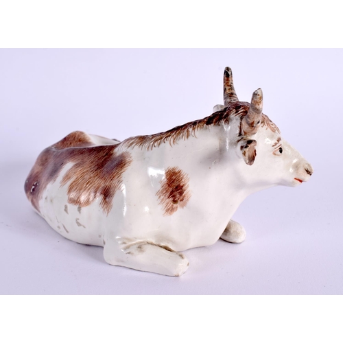 29 - A RARE 18TH CENTURY AUSTRIAN VIENNA PORCELAIN FIGURE OF A COW modelled recumbent. 12 cm x 5 cm.