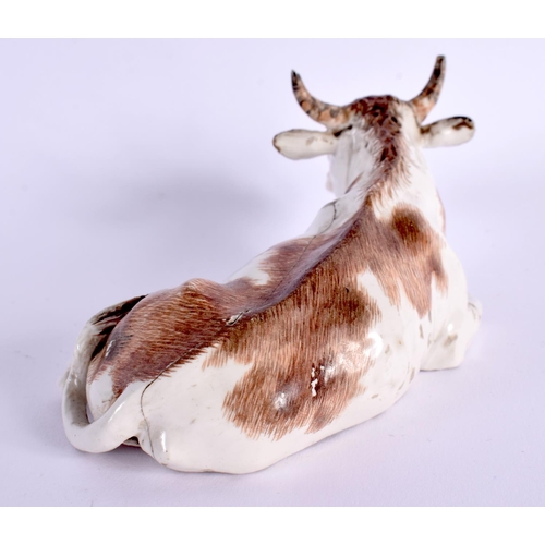 29 - A RARE 18TH CENTURY AUSTRIAN VIENNA PORCELAIN FIGURE OF A COW modelled recumbent. 12 cm x 5 cm.