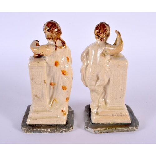 32 - A PAIR OF LATE 18TH CENTURY ENGLISH CREAMWARE POTTERY FIGURES modelled resting upon columns. 12 cm h... 